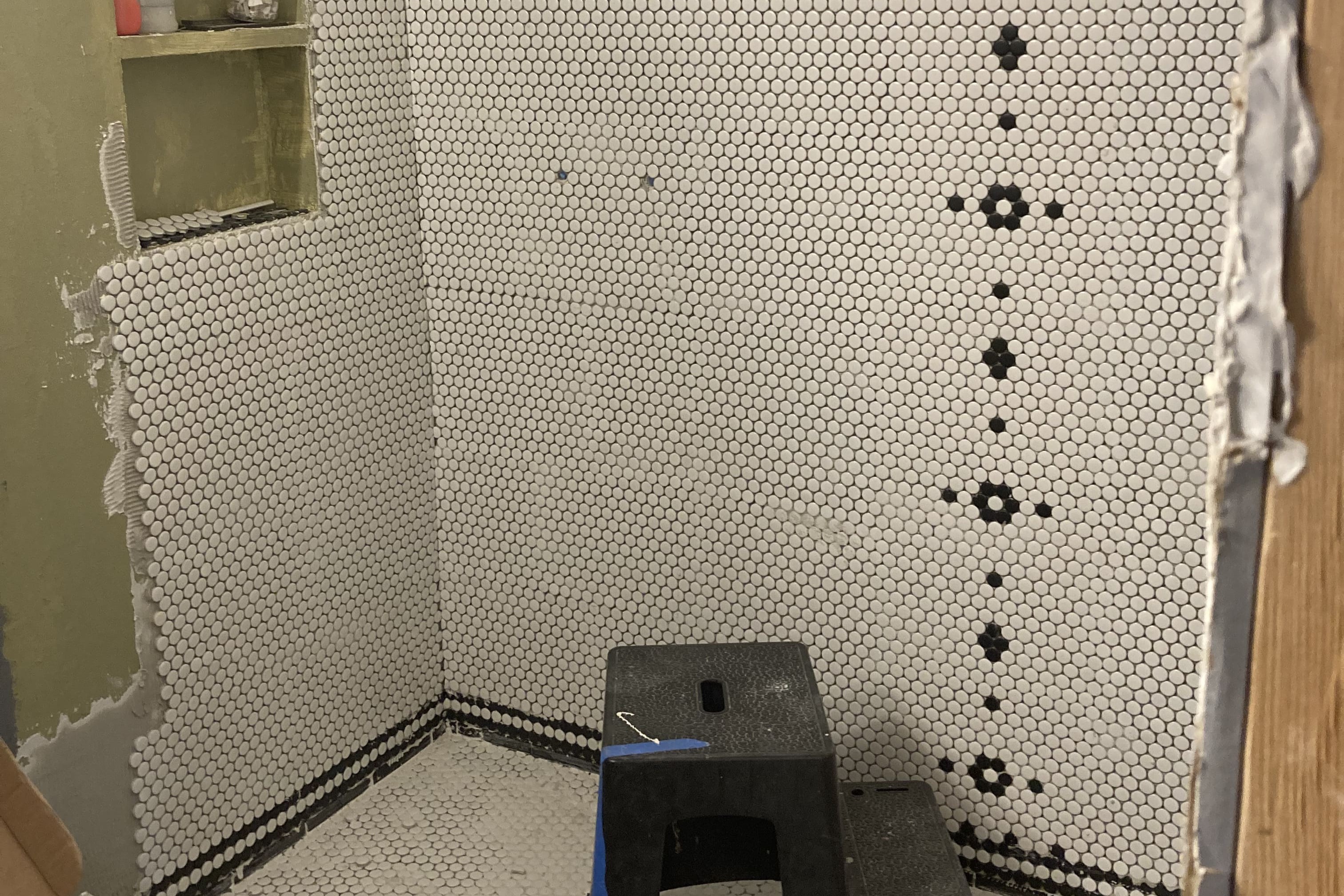 cropped image of the shower being tiled