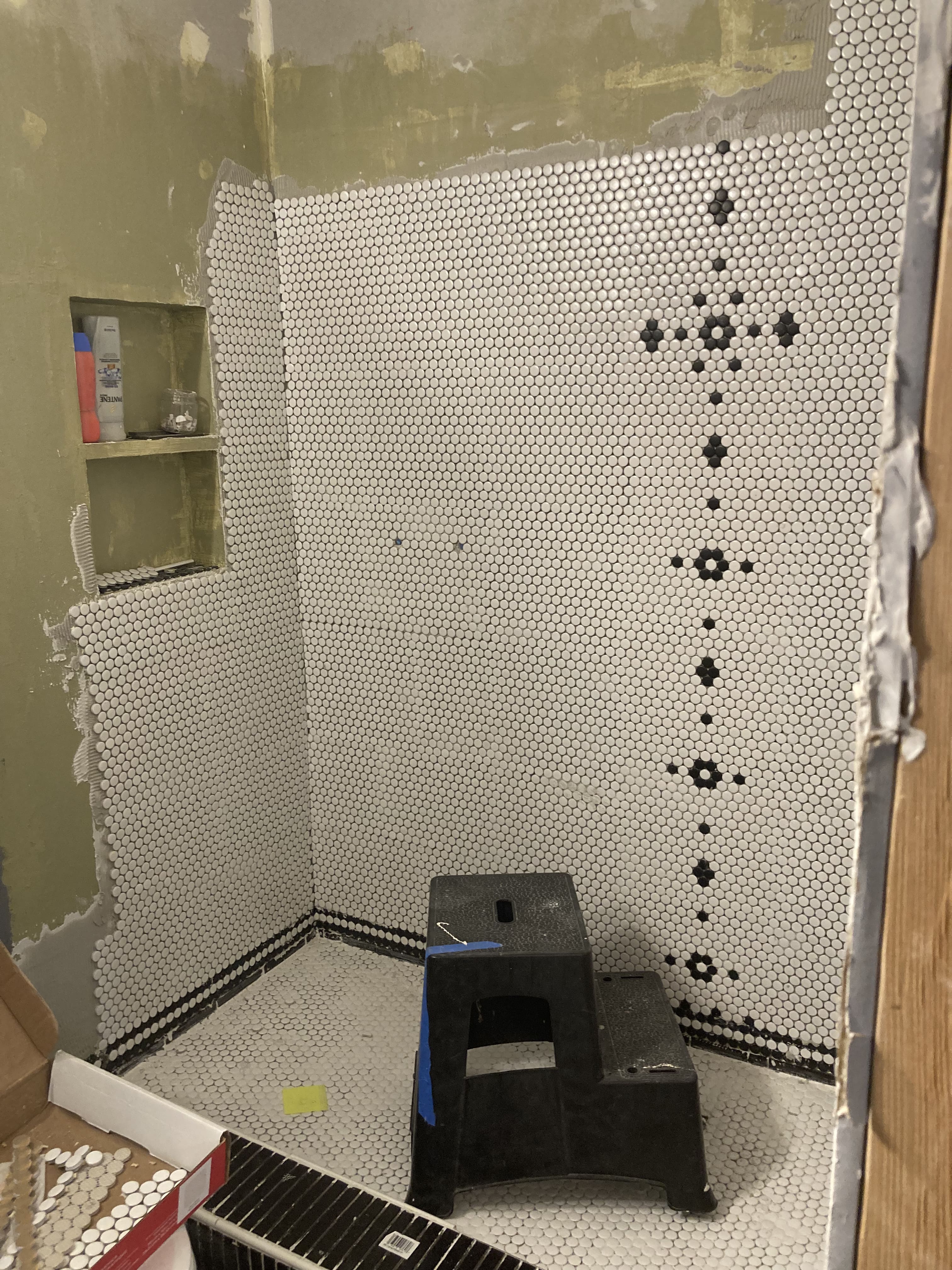 picture of a half finished shower being tiled