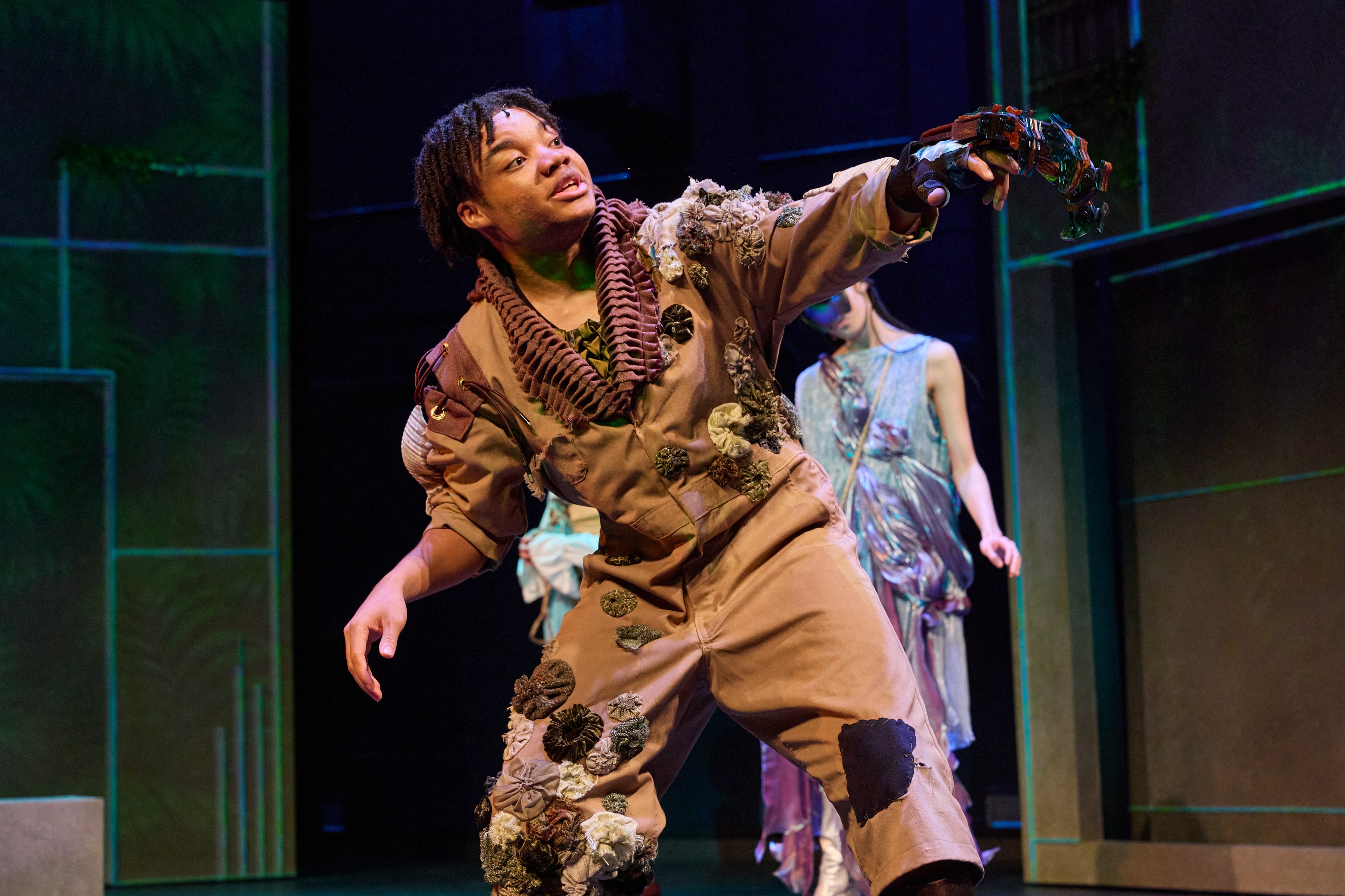 Caliban gesturing with mechanical hand